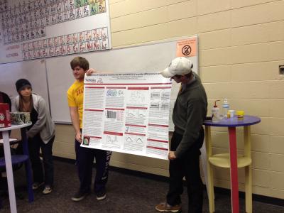 James Kizziah ('15) shows his REU poster during the Internship Workshop in 2013.